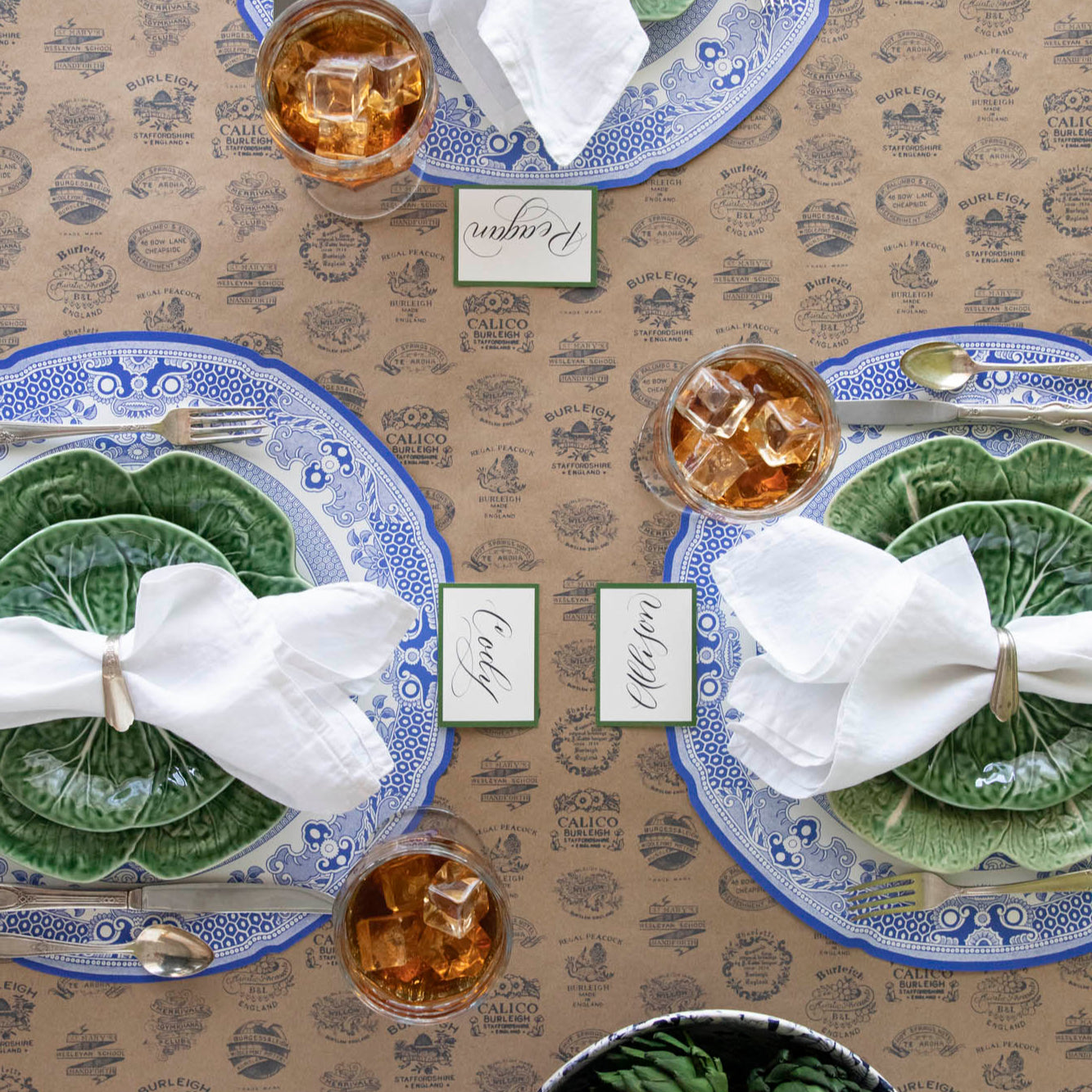 Kraft Burleigh Heritage Runner under the Die-cut Blue Willow Plate Placemat with an elegant place setting on top.