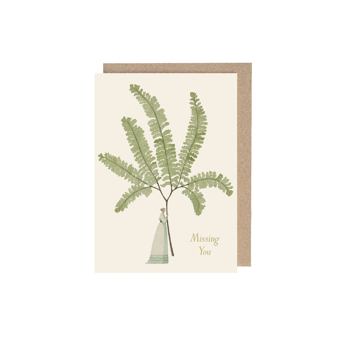 Fern 4 (Missing You) Greeting Card featuring artwork by Laura Stoddart of a woman holding a giant fern and gold text that reads "Missing You" and a kraft envelope behind.