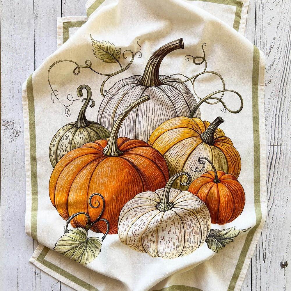 Decorative towel with pumpkins design on a wooden surface
