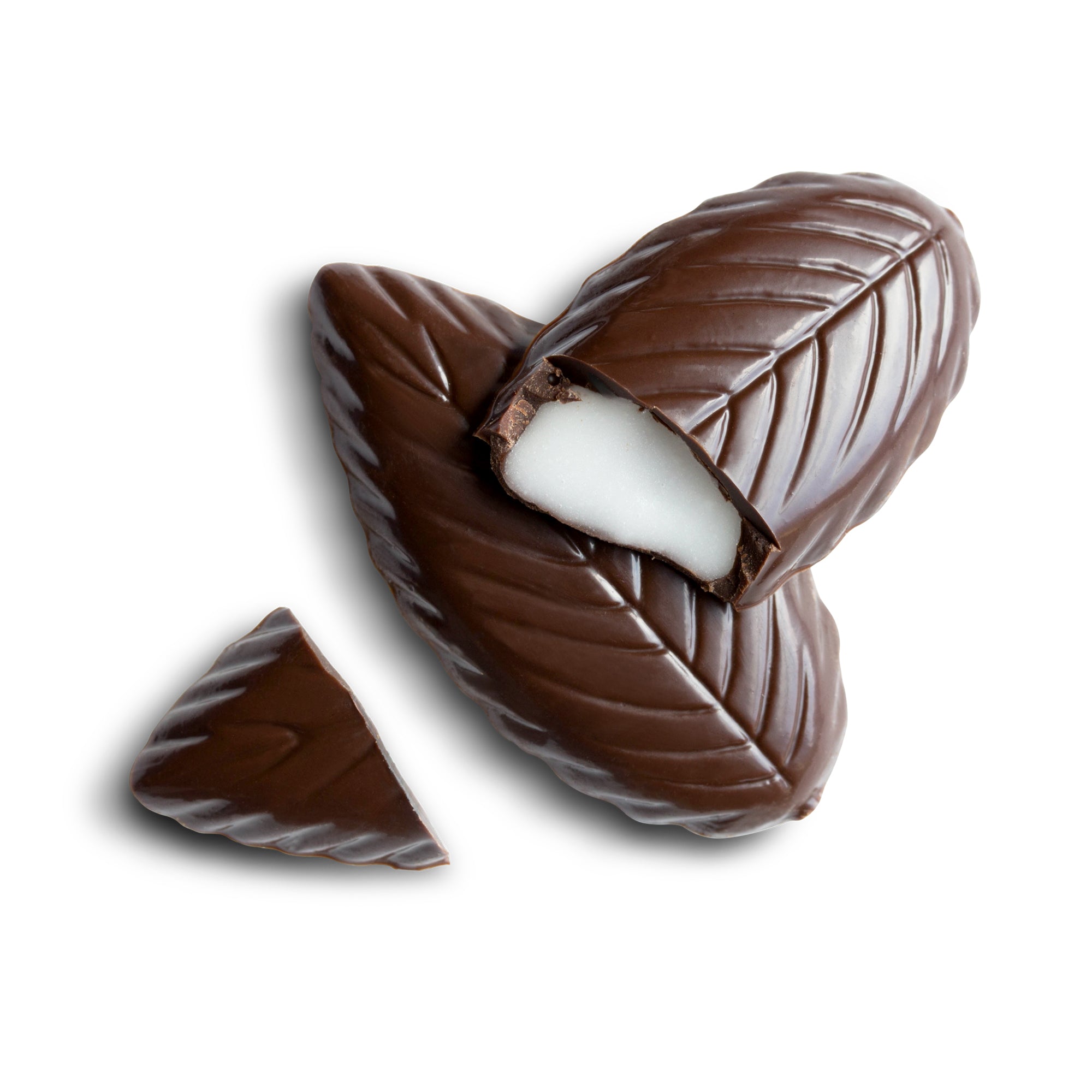 Two pieces of chocolate shaped like mint leaves with one open showing the mint filling.