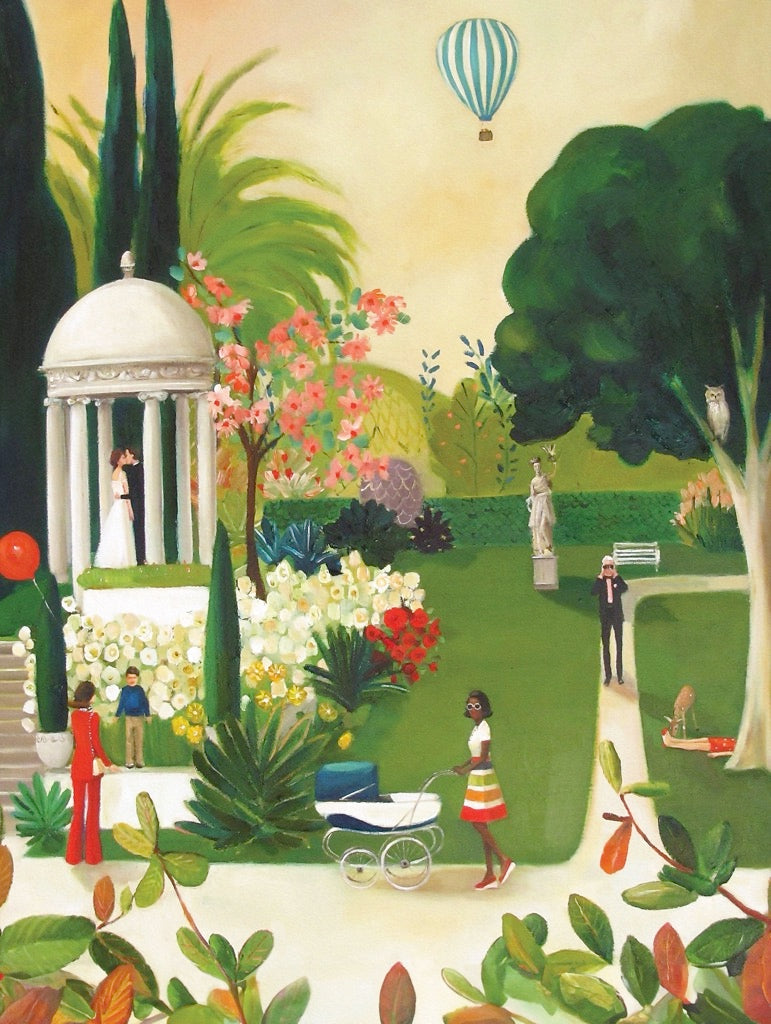 A New York Puzzle Company jigsaw puzzle box featuring an illustration by artist Janet Hill of a serene botanical garden scene with a hot air balloon in the sky.