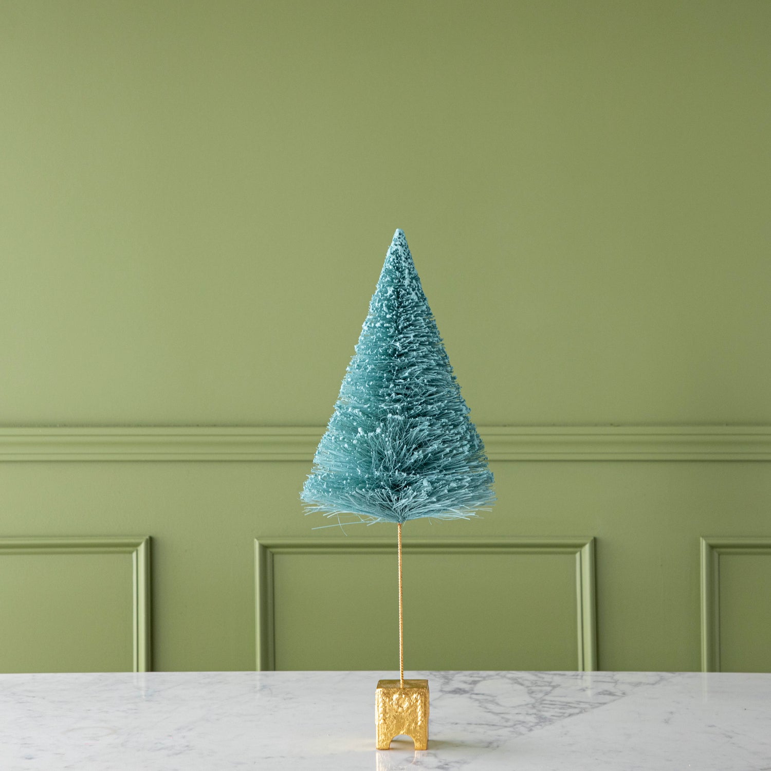 A 22" Mint French Forest Sisal Tree with a gold base, on a marble table.
