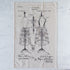 Tea towel with dress form patent design on a textured surface.