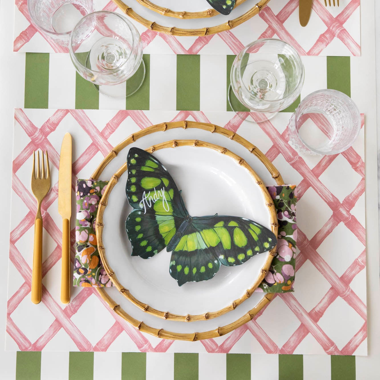 Pink Lattice Placemat on the Moss Green Stripe Runner, with the Butterfly Table Accent resting on the dinner plates of a place setting.