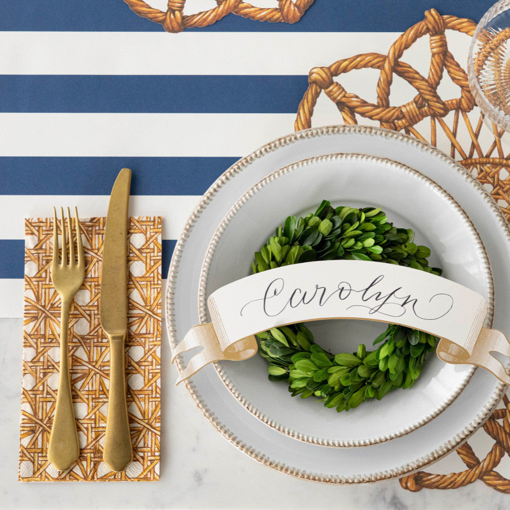 An elegant place setting featuring a Rattan Weave Guest Napkin, from above.