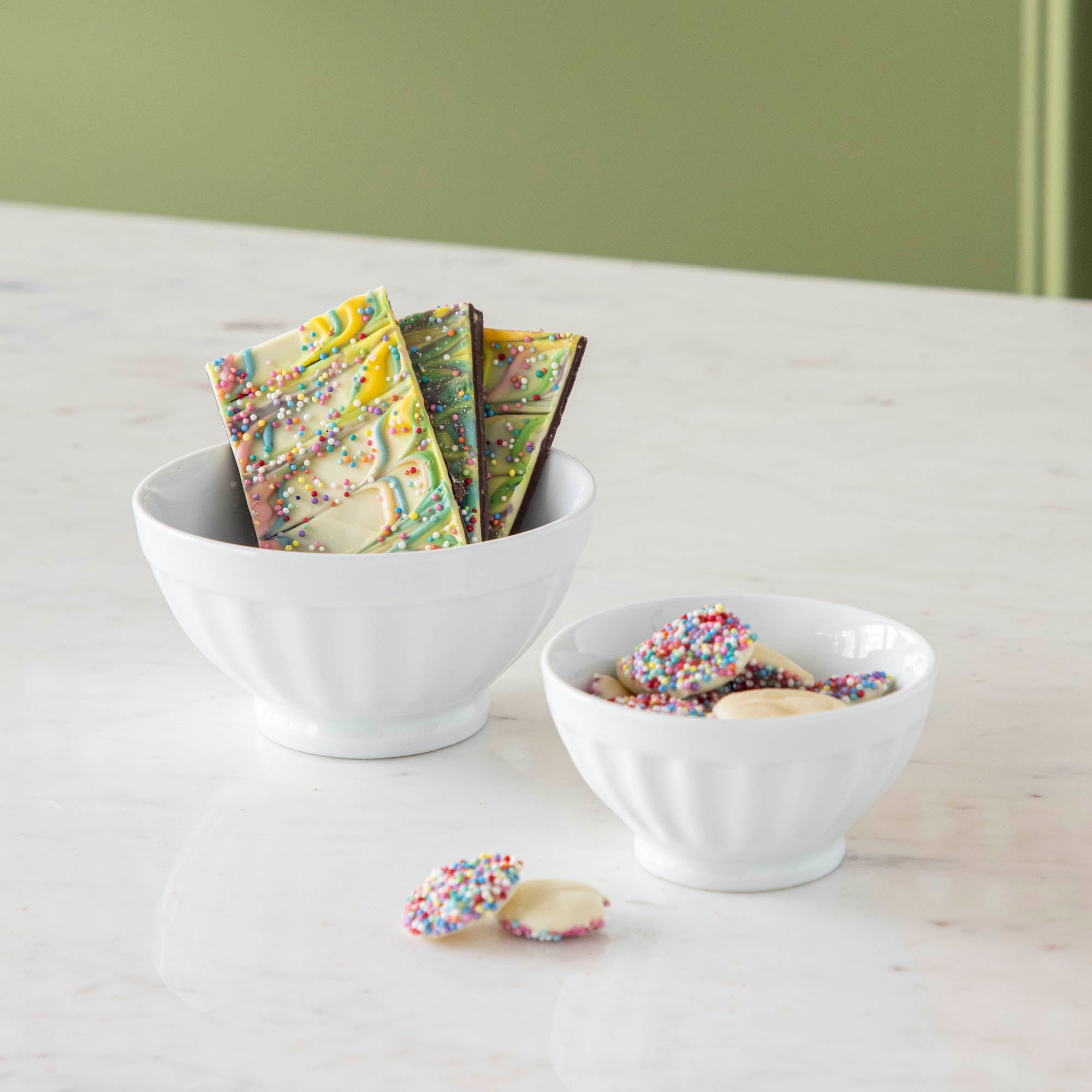 White Fluted Bowl with chocolate in them. 