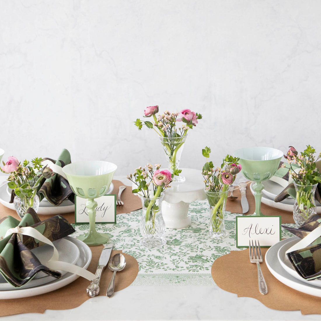A row of Dublin Crystal 5 Piece Bud Vase Set by Godinger with fresh flowers - perfect for adding a touch of beauty to any space.