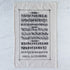 Old English Tea Towel featuring the alphabet and numbers in old english font on a marble table.