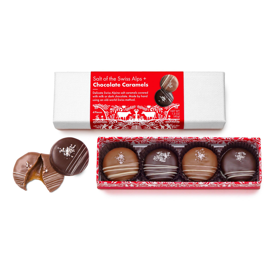 A Swiss Heritage gift box containing chocolate caramels. The box is red with white snowflake designs and the caramels are displayed in a transparent section showing round chocolates with a caramel center, coated in milk and dark chocolate.