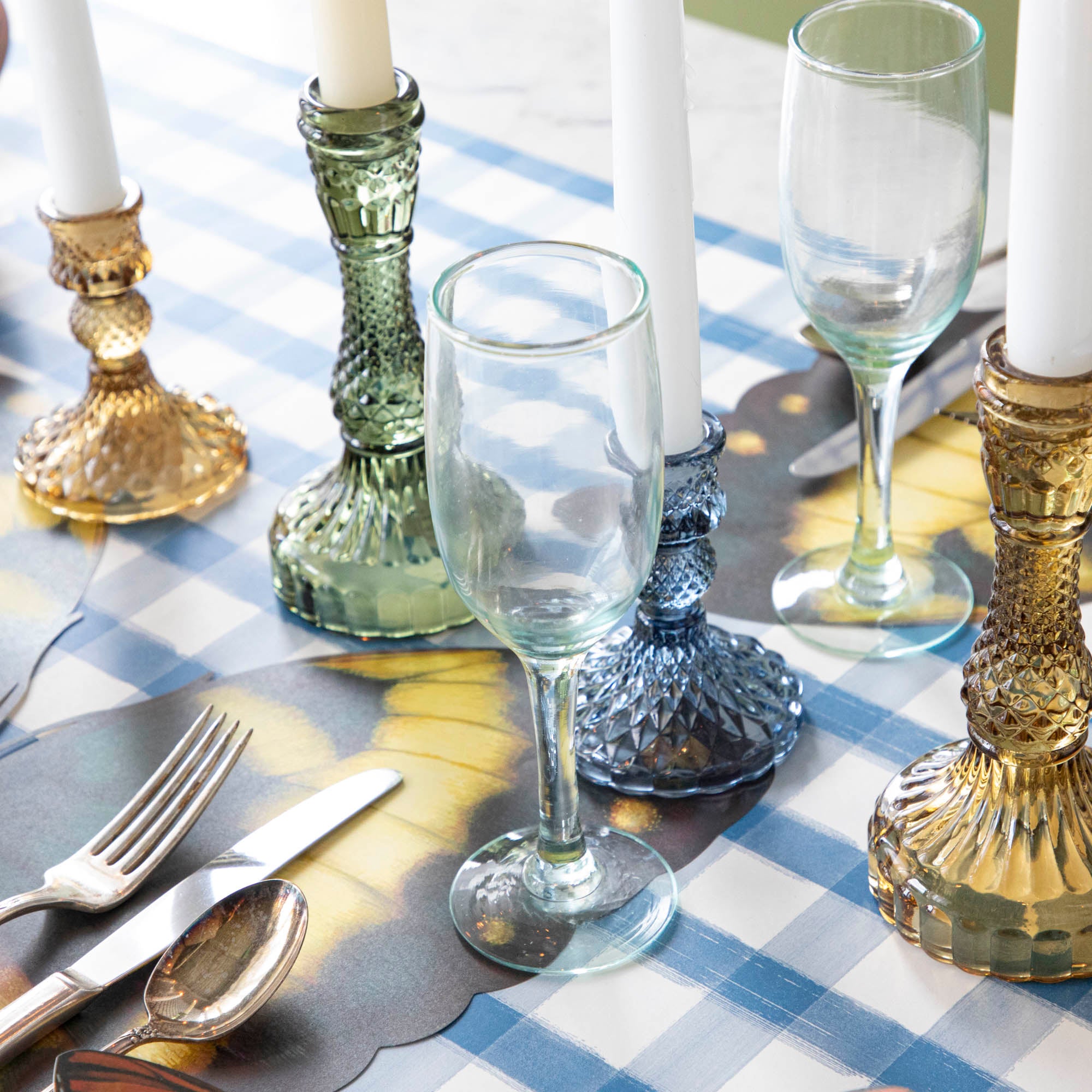 Four Accent Decor vintage amber candlesticks on a table.