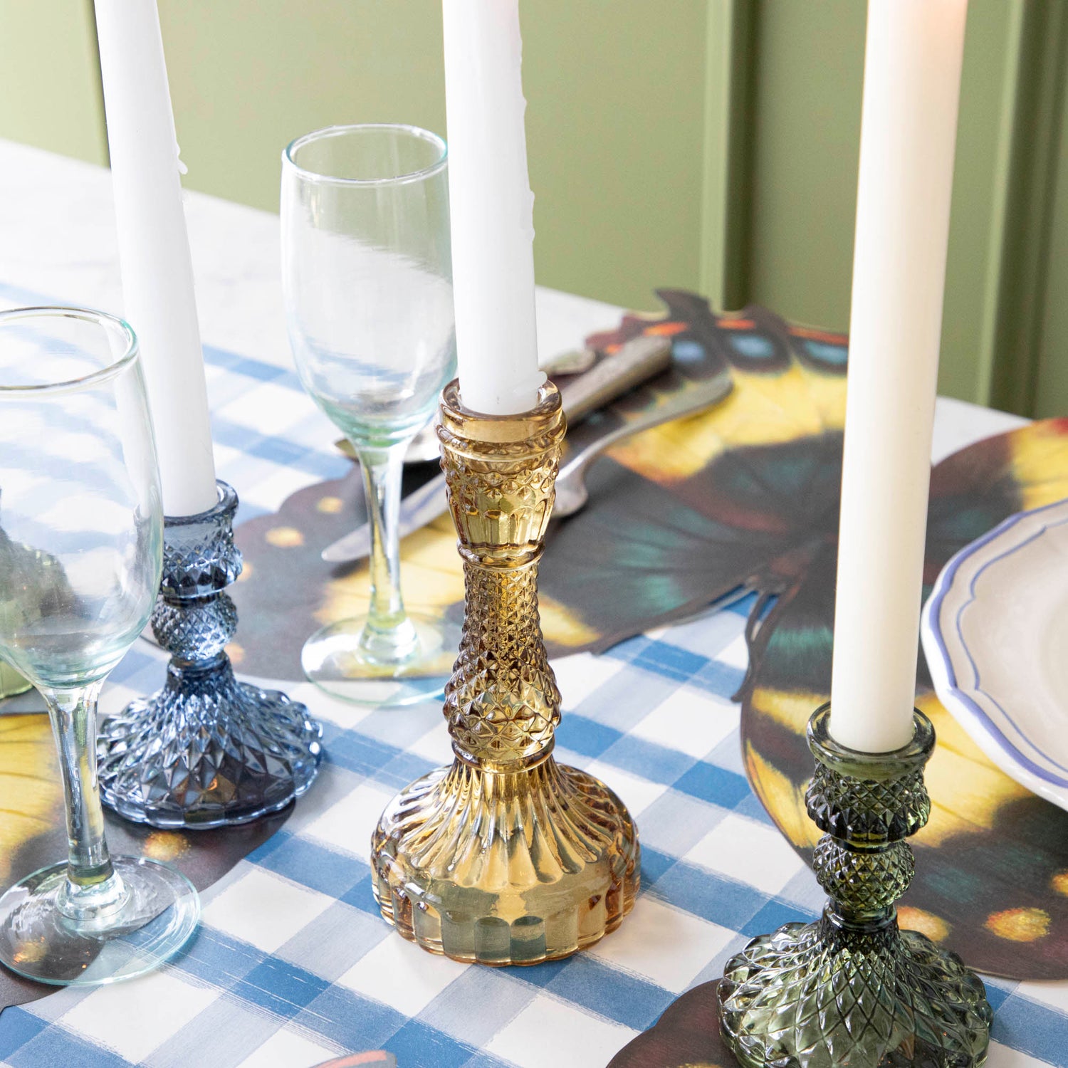 Close-up of an amber candle holder on a set table. 