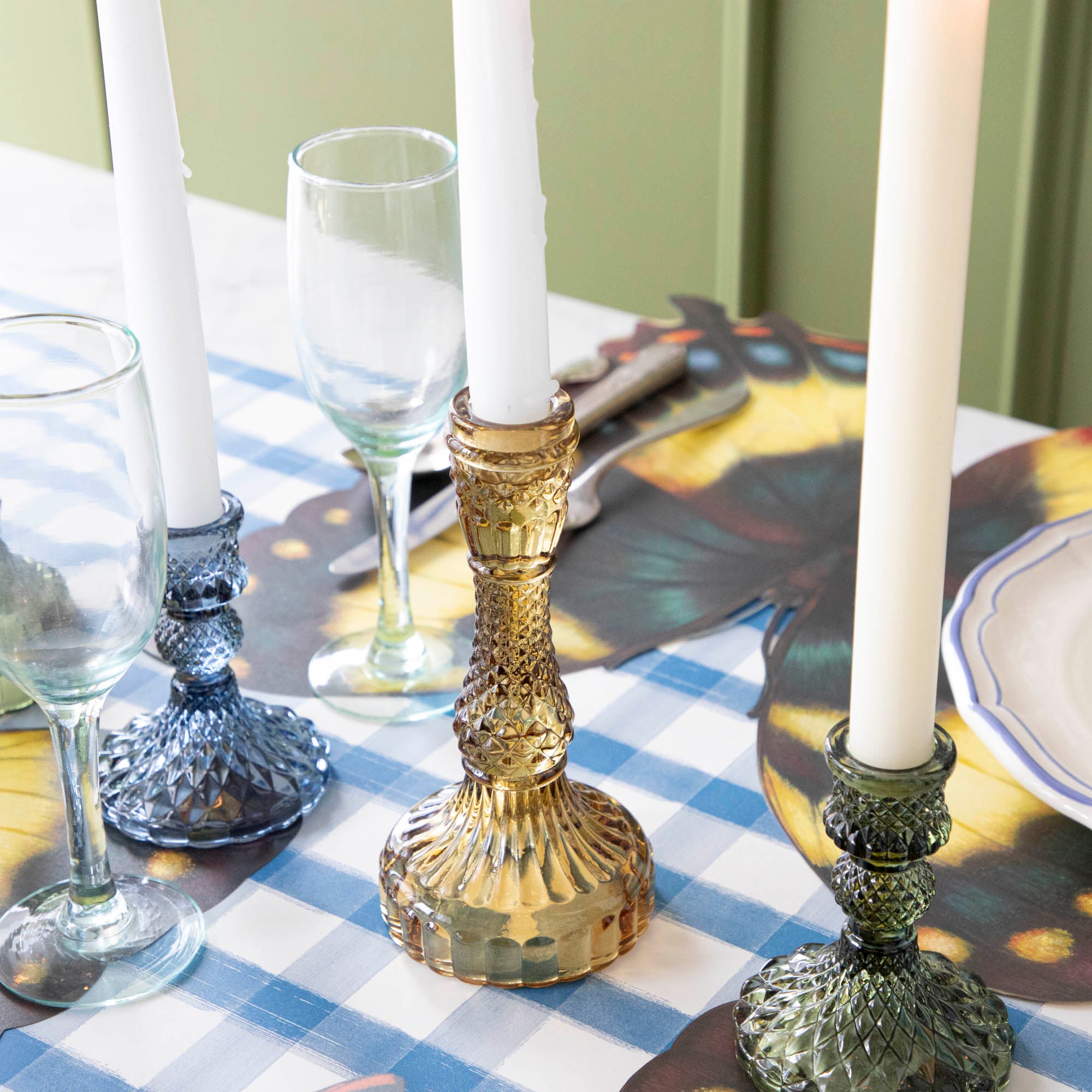 Close-up of an amber candle holder on a set table. 