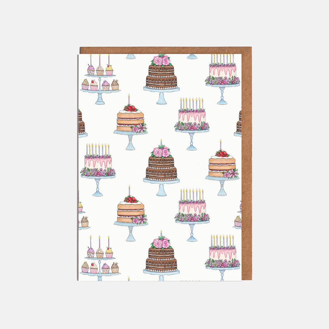 Pattern of cakes printed on a greeting card on a white background.