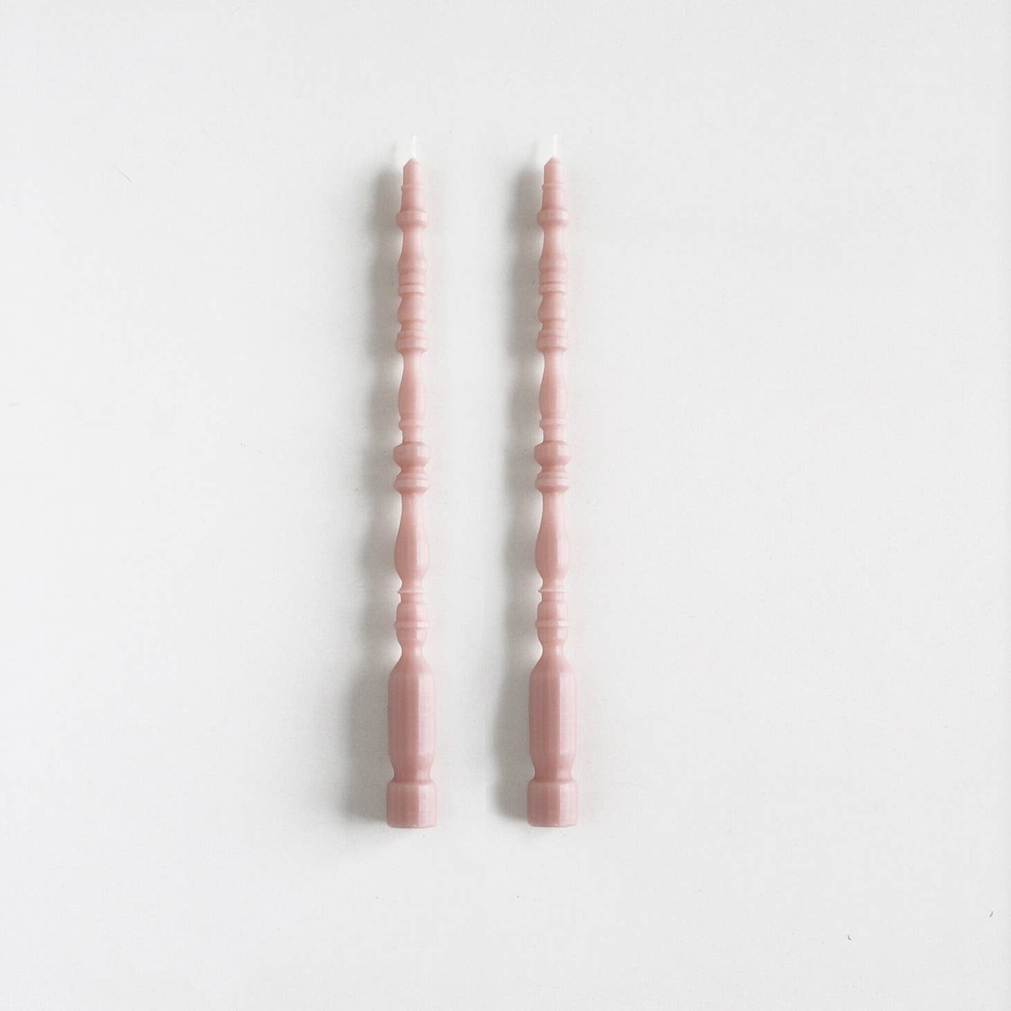 2 taper candles shaped like table spindle legs in smoked lilac.