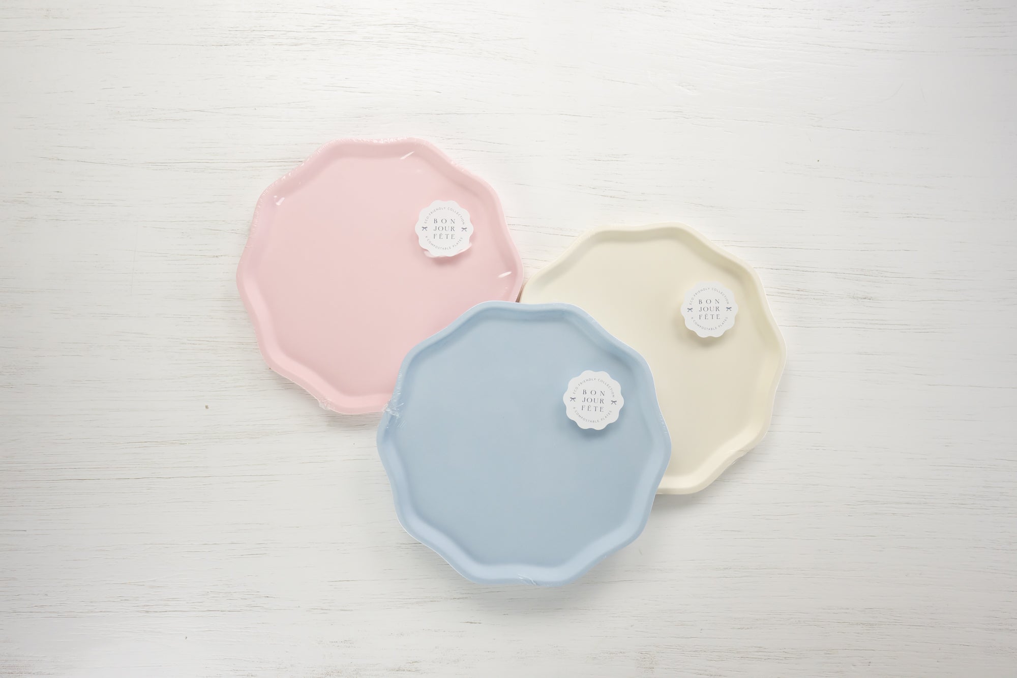 Three pastel-colored plates on a light gray background