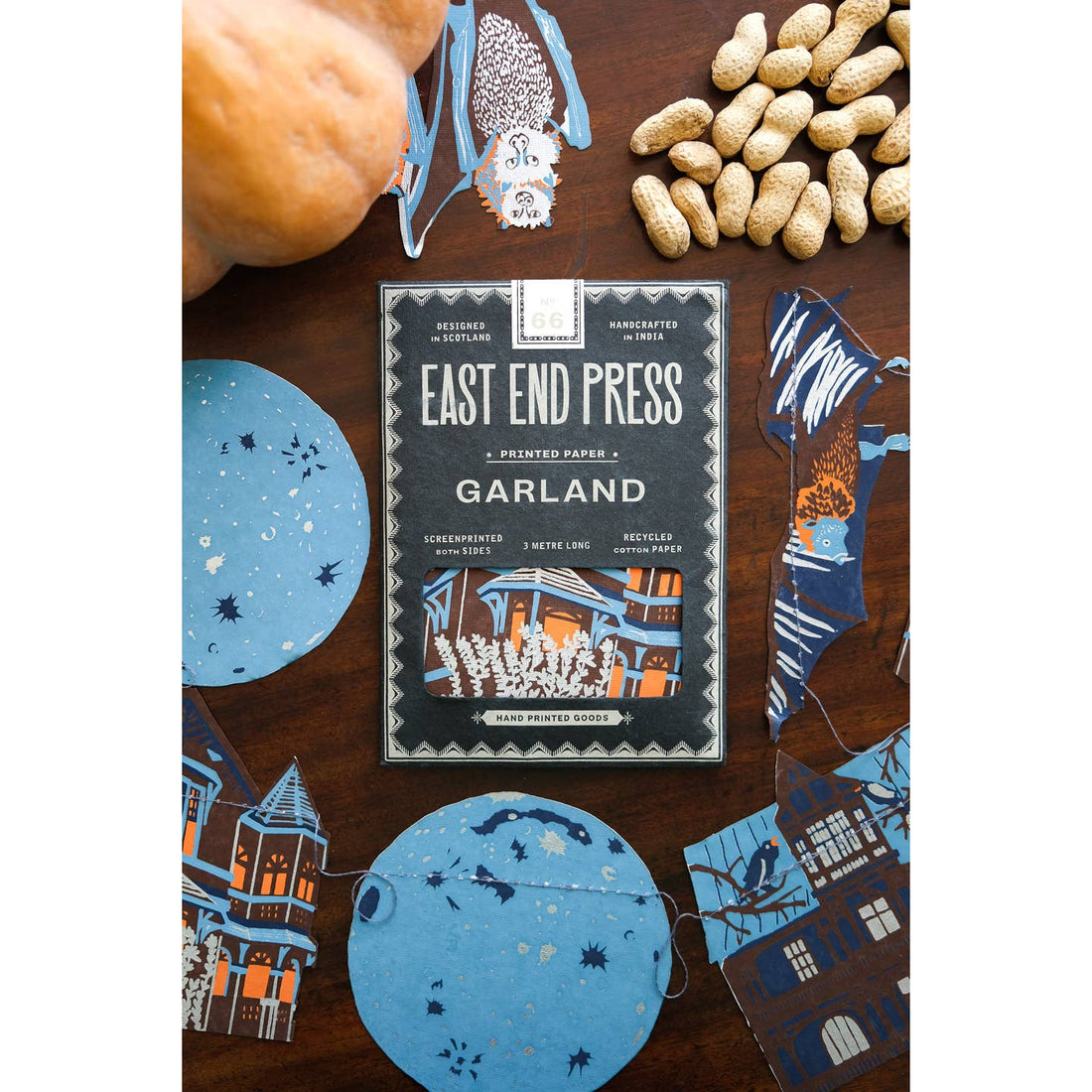 Package of the Haunted House sewn garland on a table surrounded by the garland. 