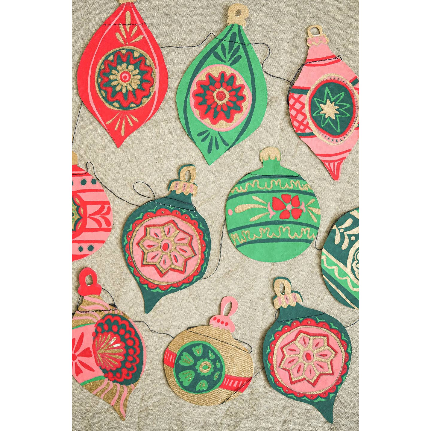 Colorful Christmas ornament garland decorations on a textured background