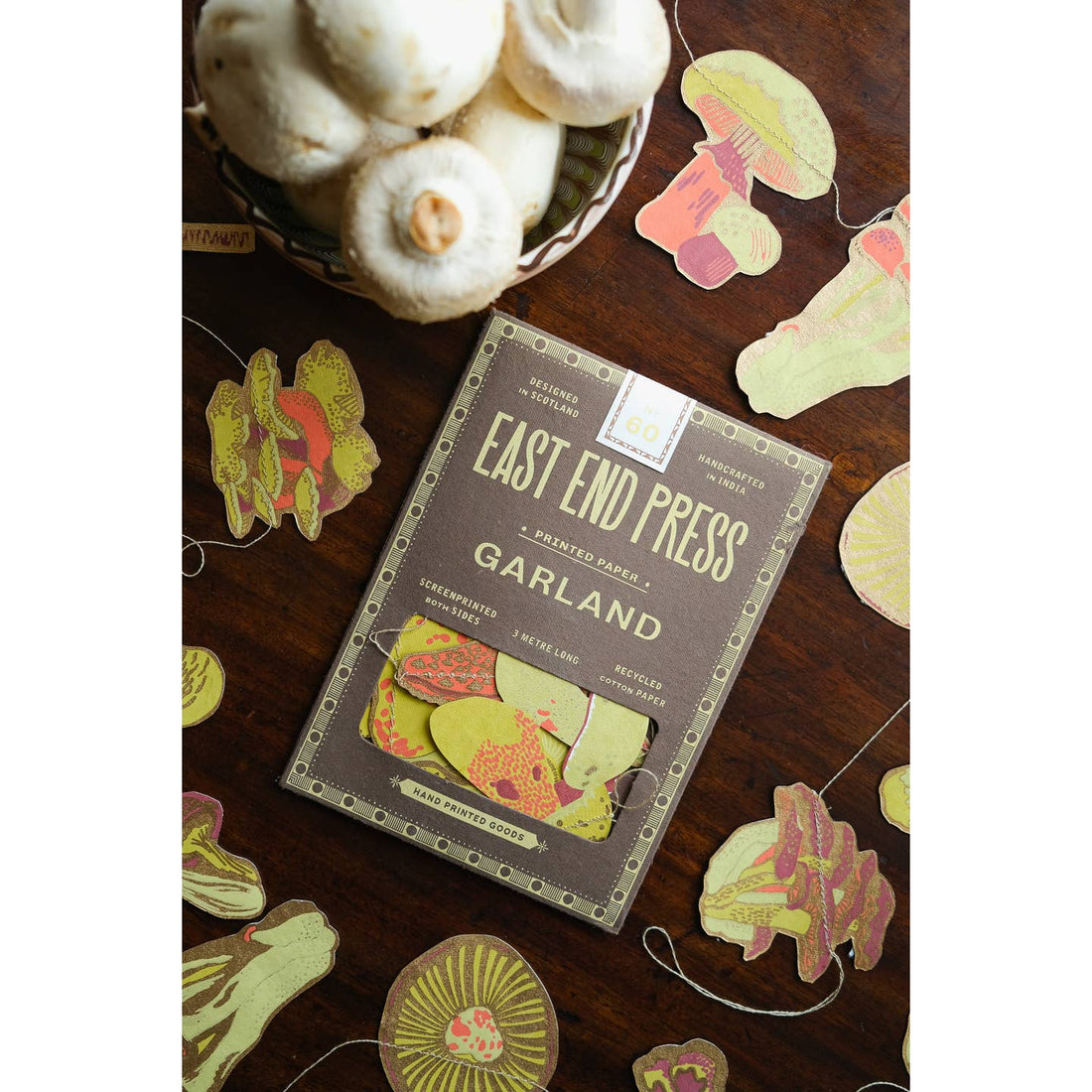 Front of package for the mushroom garland surrounded by the mushroom garland. 