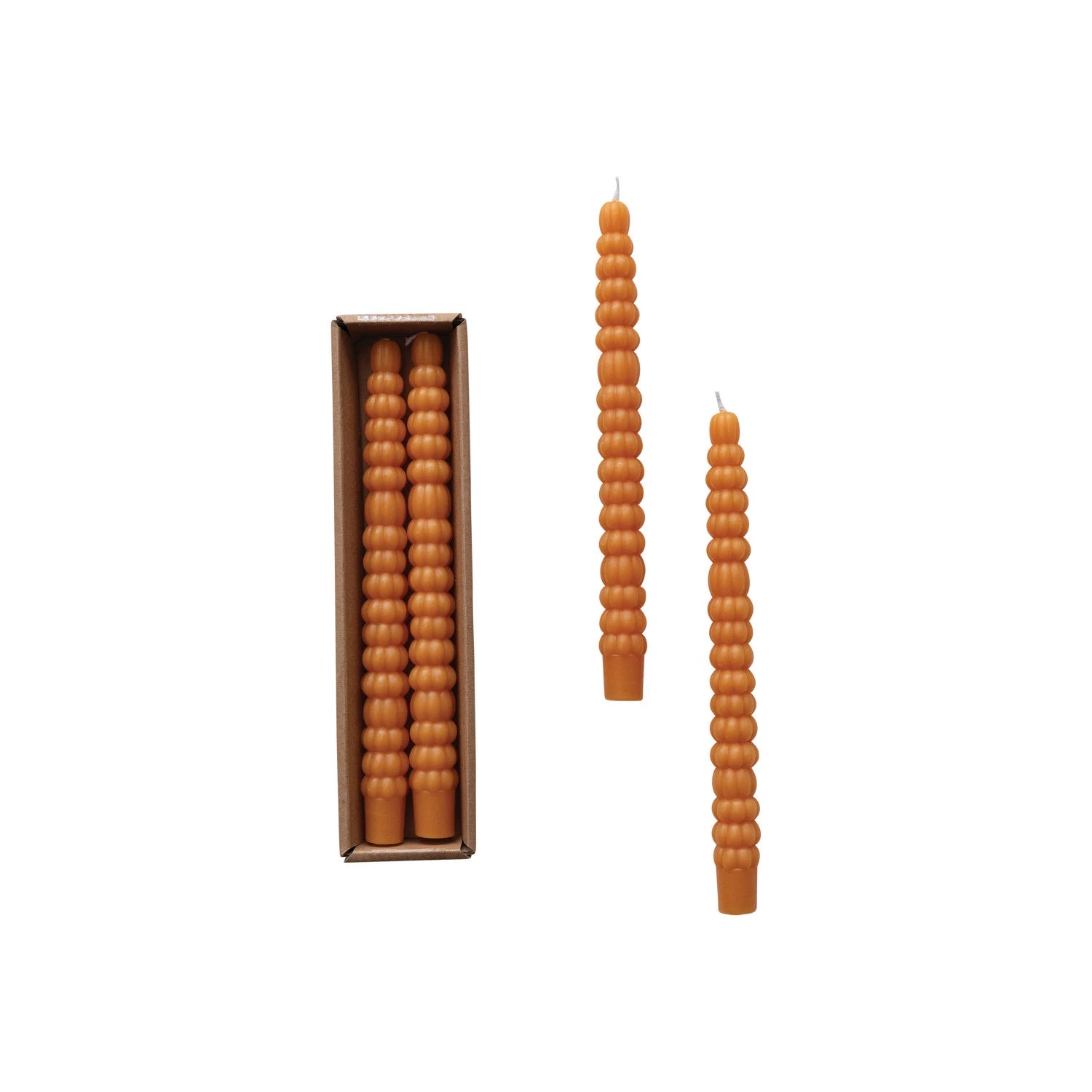 The pumpkin taper candles, shown in and out of their package on a white background.