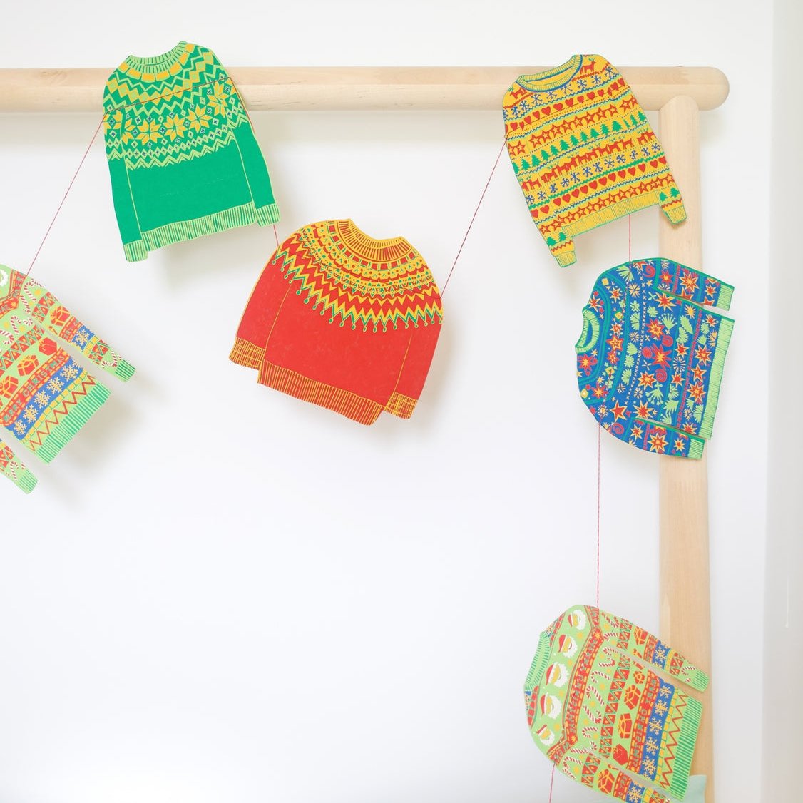 Close up of the sweater garland draped over a pole.