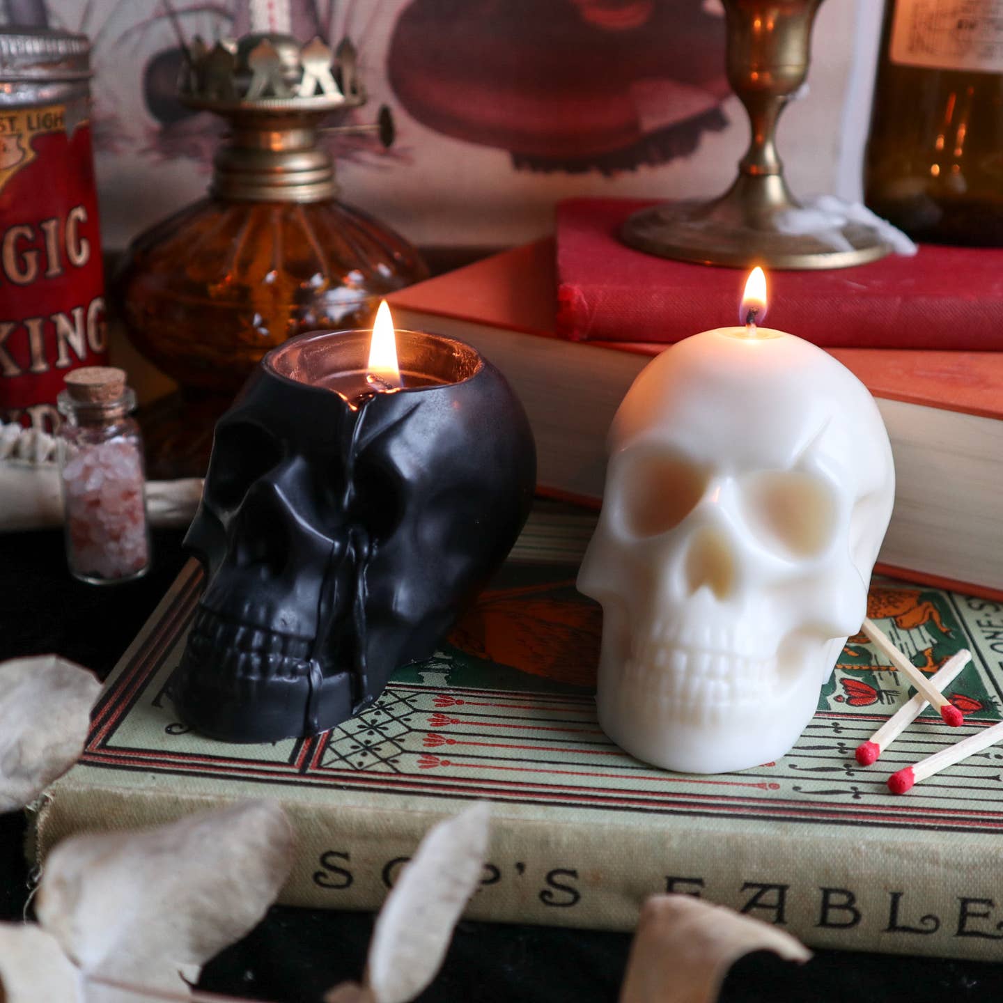 Black and cream skull shaped candle burning. 