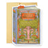 Die-cut greeting card in the shape of a book cover printed with gold foil lettering saying "May this year be another beautifully written chapter in the story of your life."