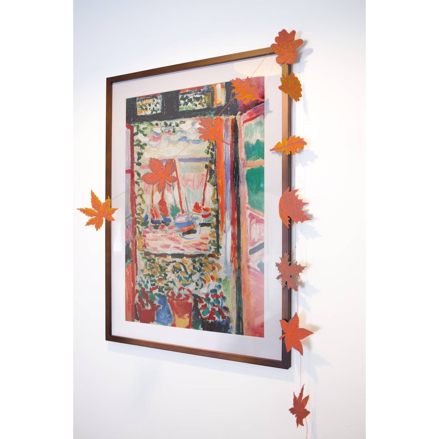 Autumn Leaves Sewn Garland hanging on an art print.