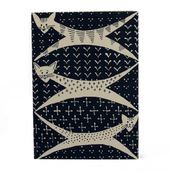 Greeting card by Cambridge Imprints with illustration of 3 cream cats on a black background. 