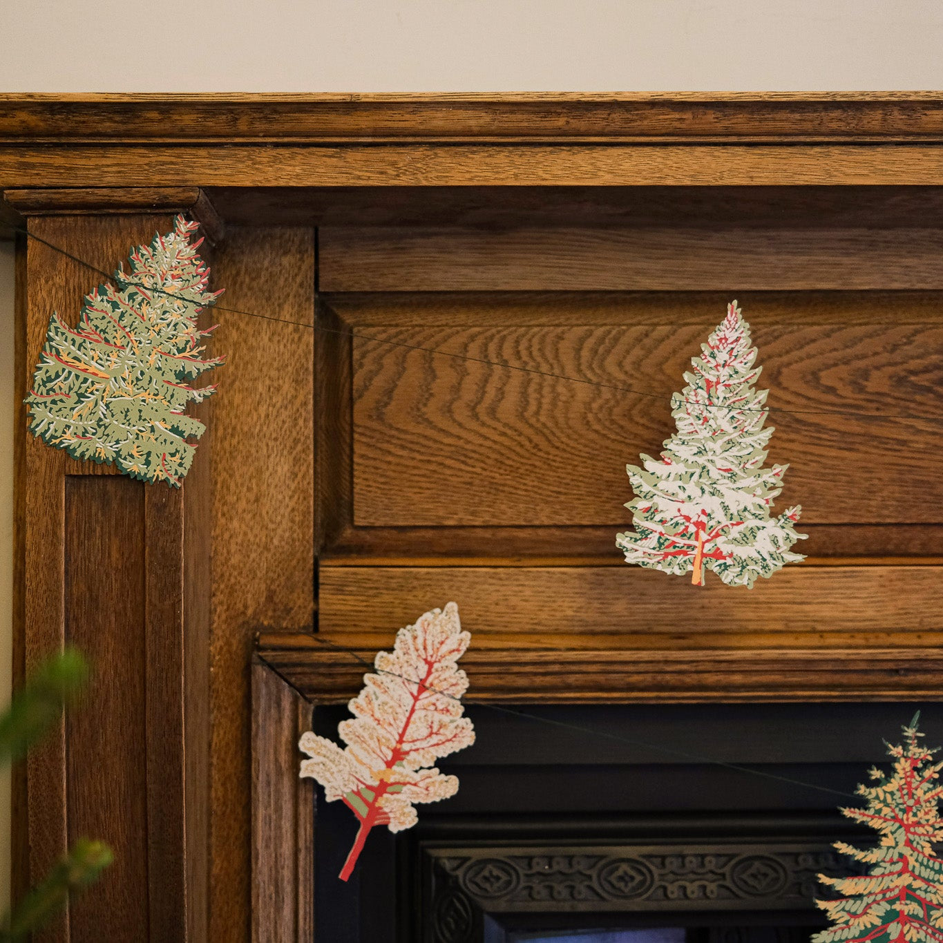 Decorative Christmas trees on a wooden mantelpiece