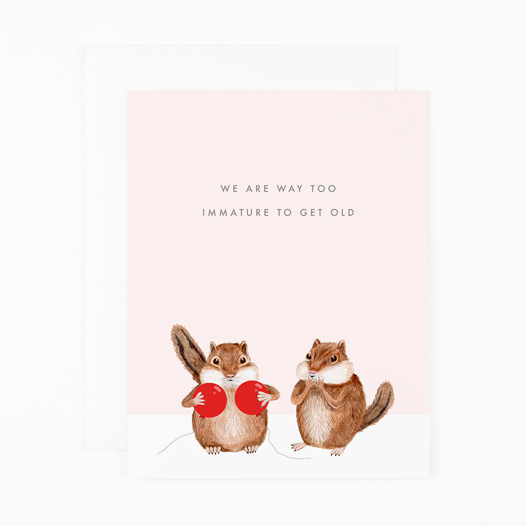 A card with text that reads "We are too immature to get old" featuring one chipmunk holding two red balloons over its chest and another with its hands over its mouth.