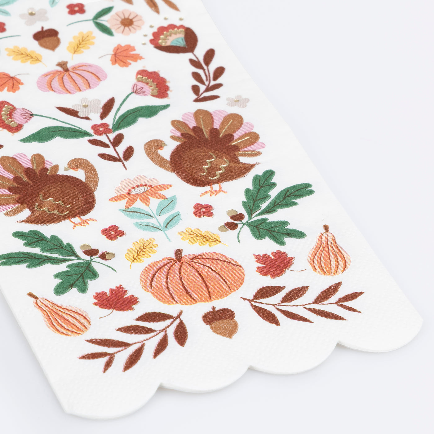 Decorative paper napkin with autumn-themed illustrations including turkeys, pumpkins, and leaves on a white background.