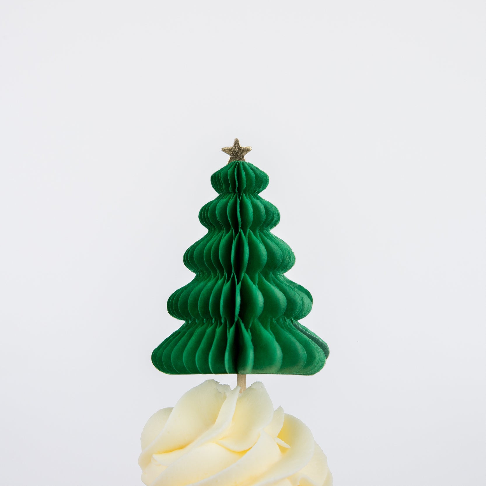 A honeycomb tree topper topped on a cupcake.