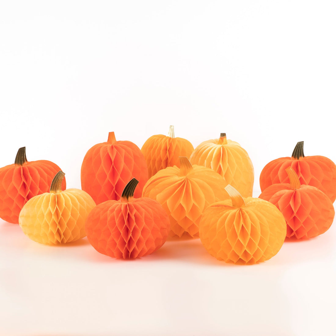 Ten Honeycomb Pumpkins on a white background.