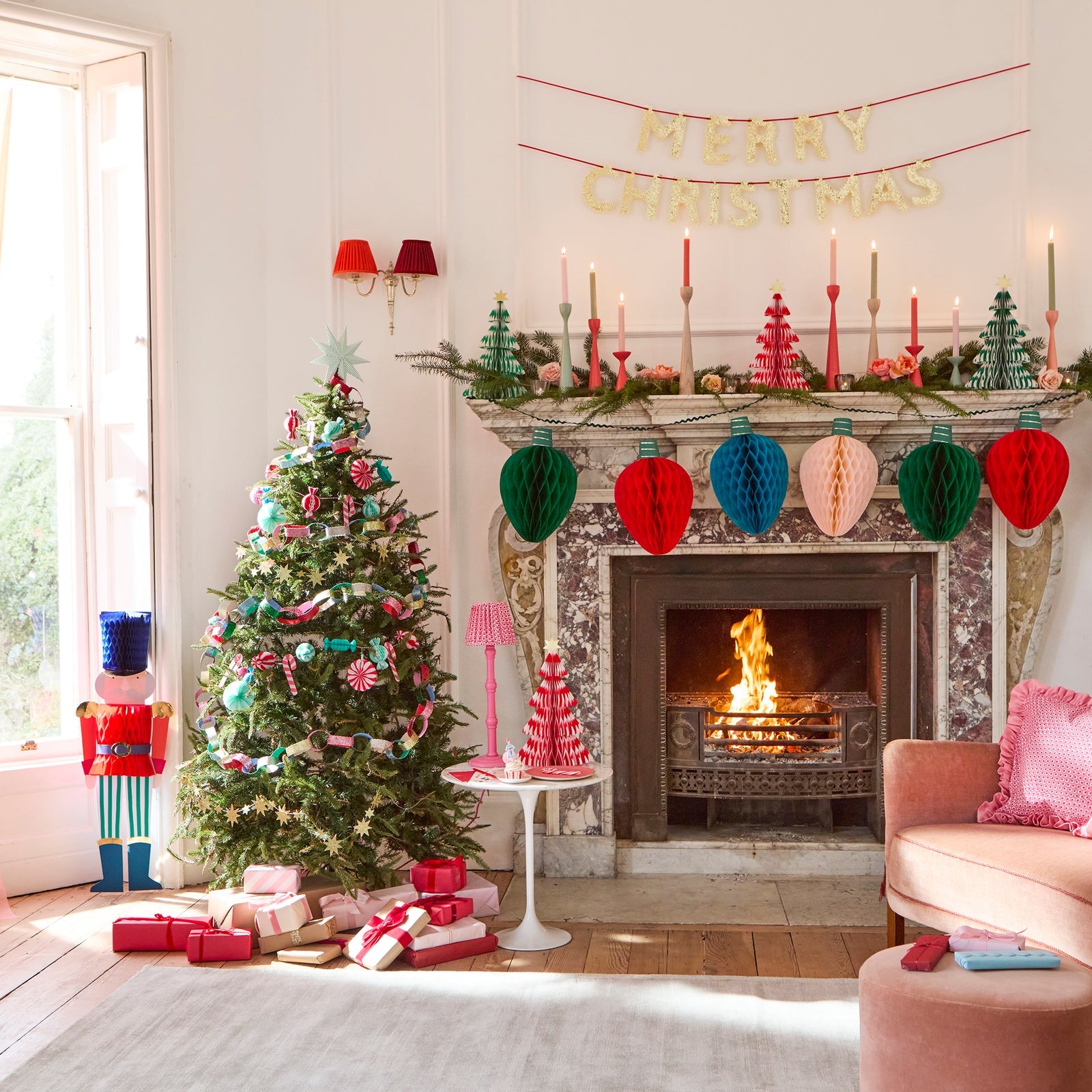 Cozy living room decorated for Christmas with a tree, fireplace, and festive decor.