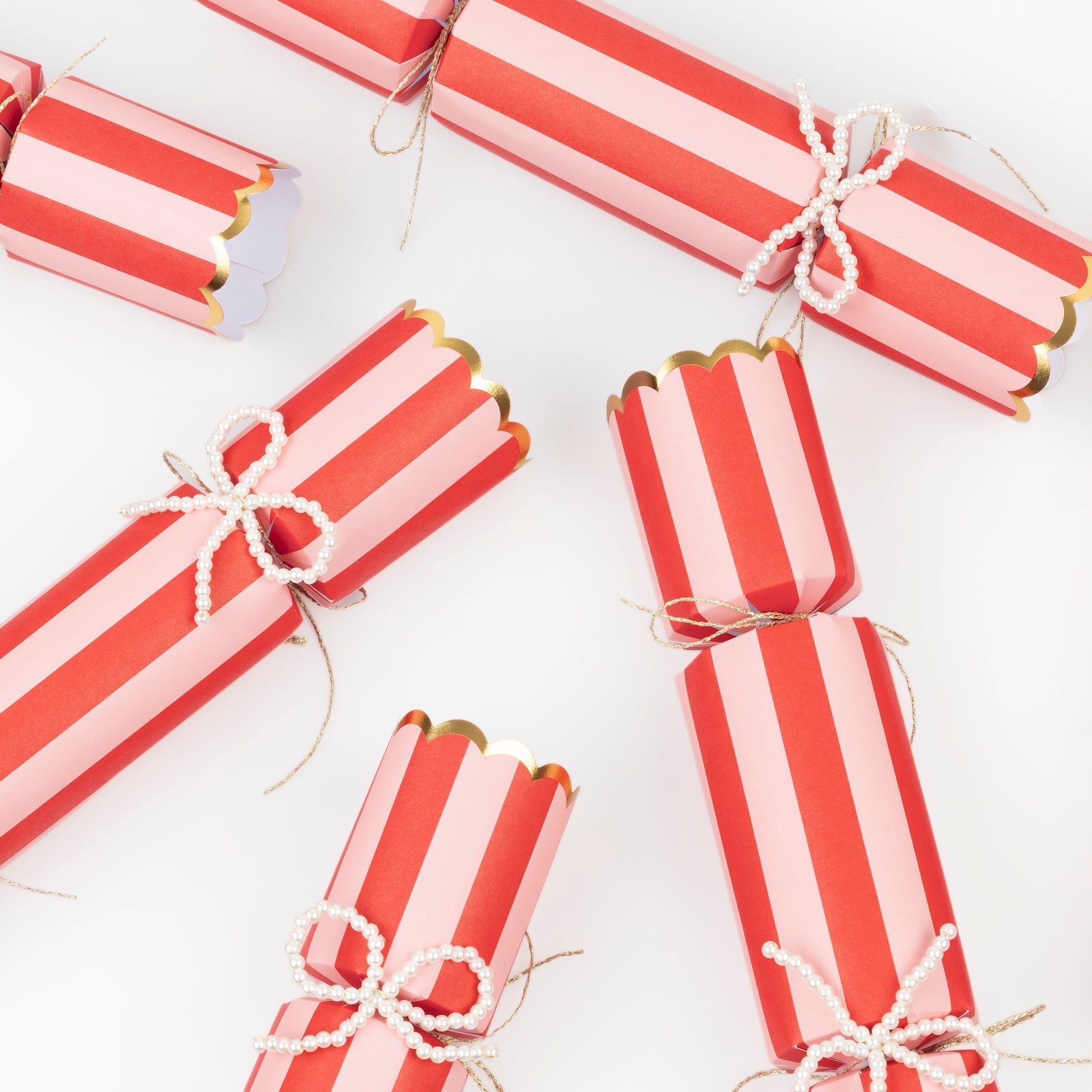 Red and white striped crackers tied with string on a white background