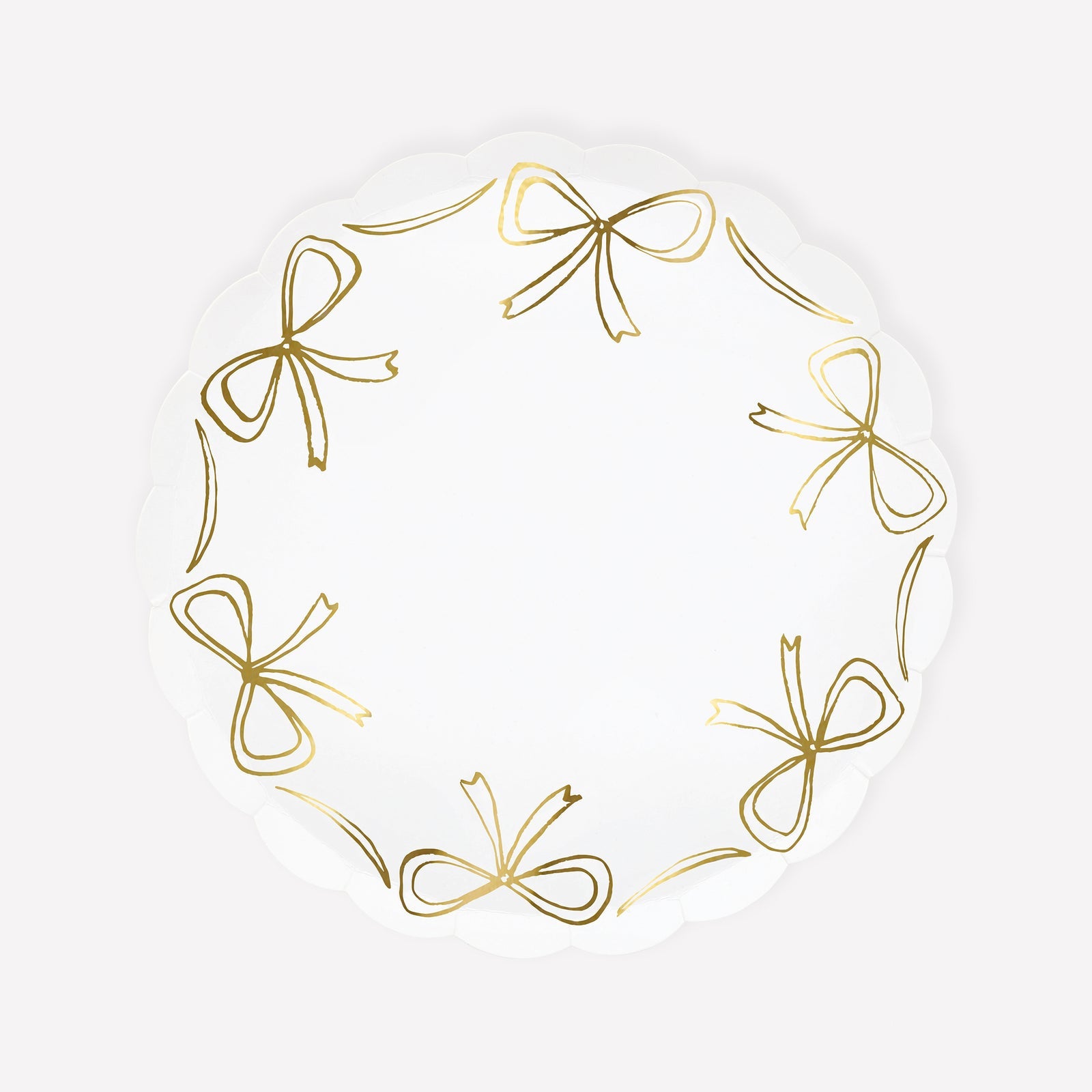 Paper plate by Meri Meri with gold bow illustrations around the edge.