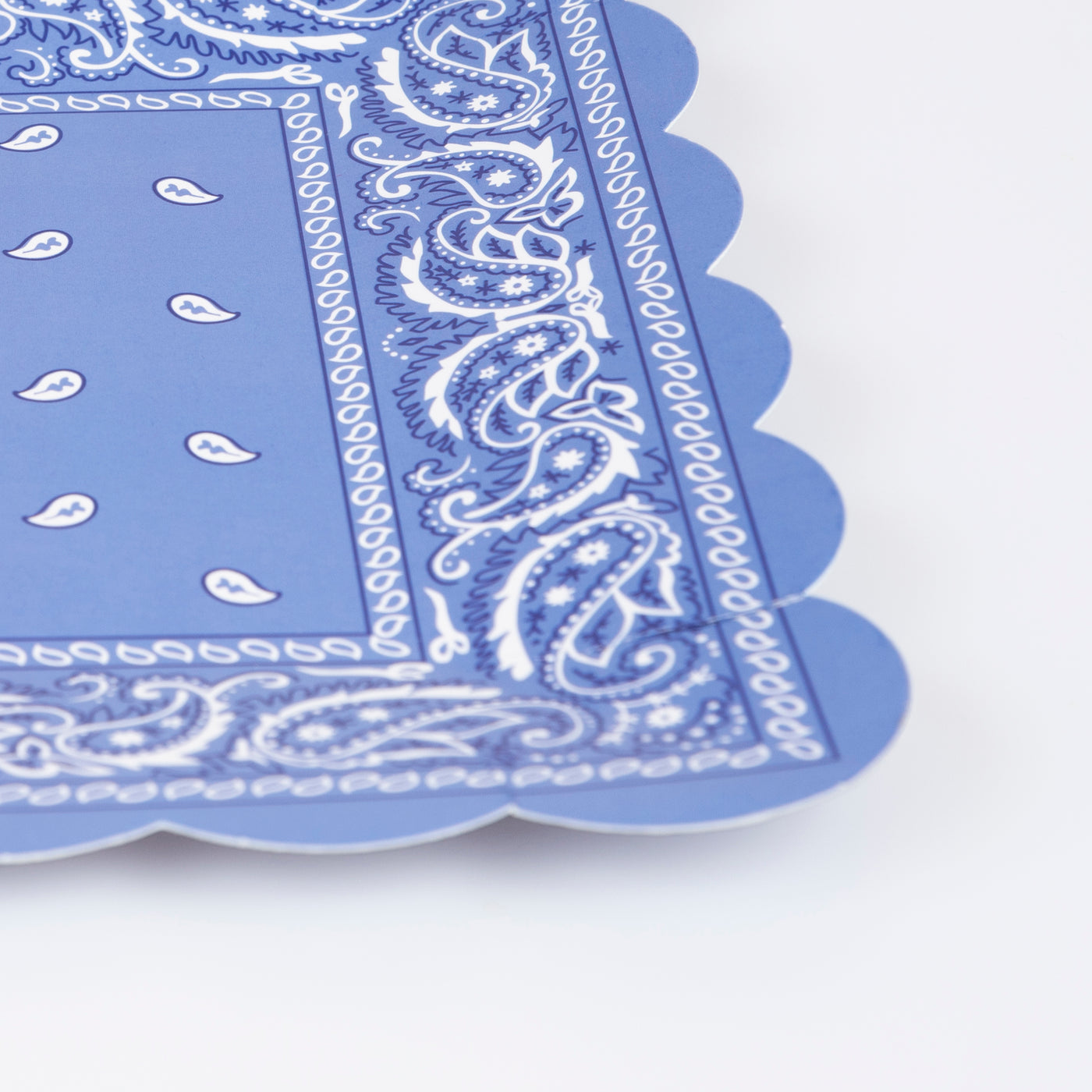 A close up of the blue Western Bandana Square Plates showing the scalloped border.