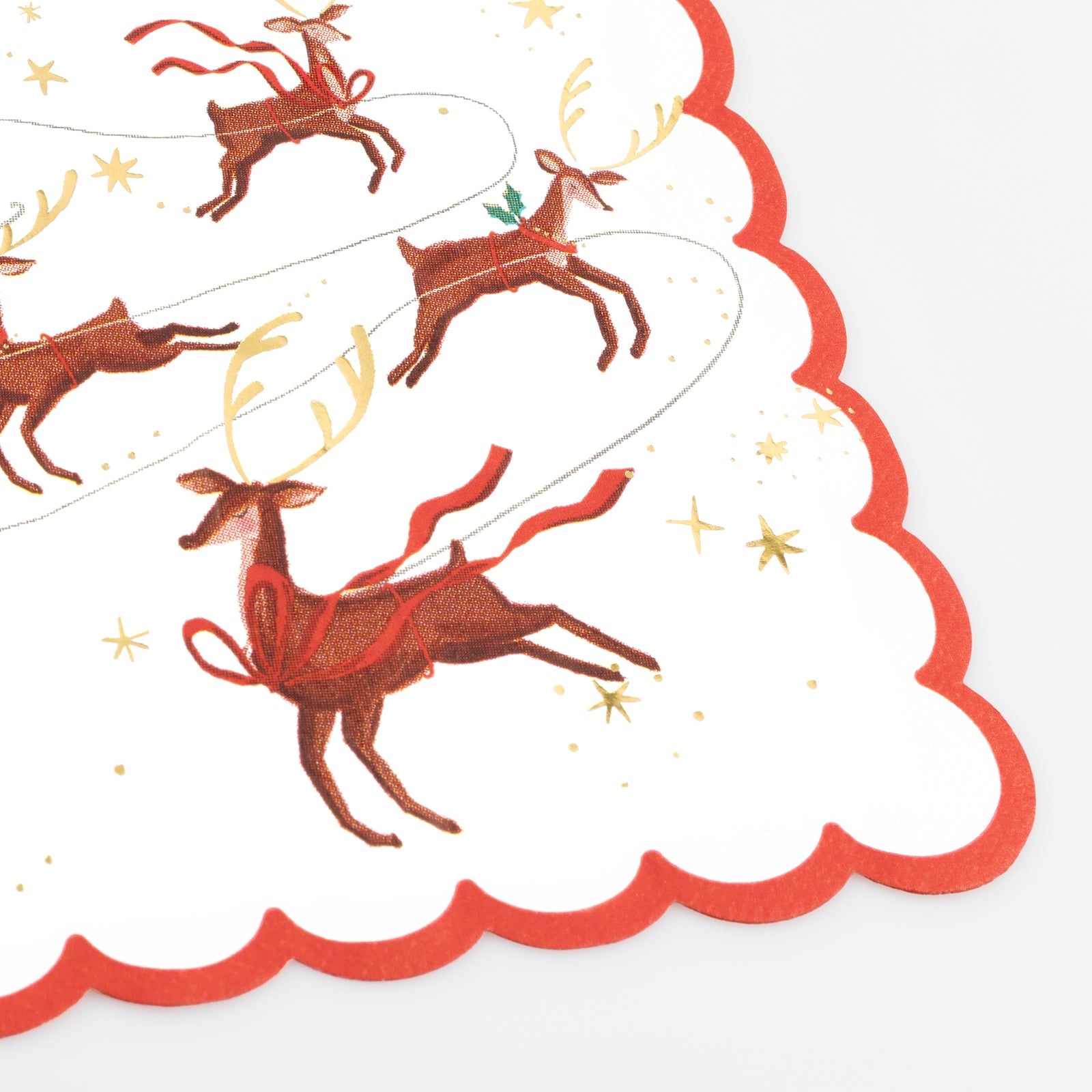 Decorative paper napkin from Meri Meri featuring an illustration of Santa and his reindeer on it.