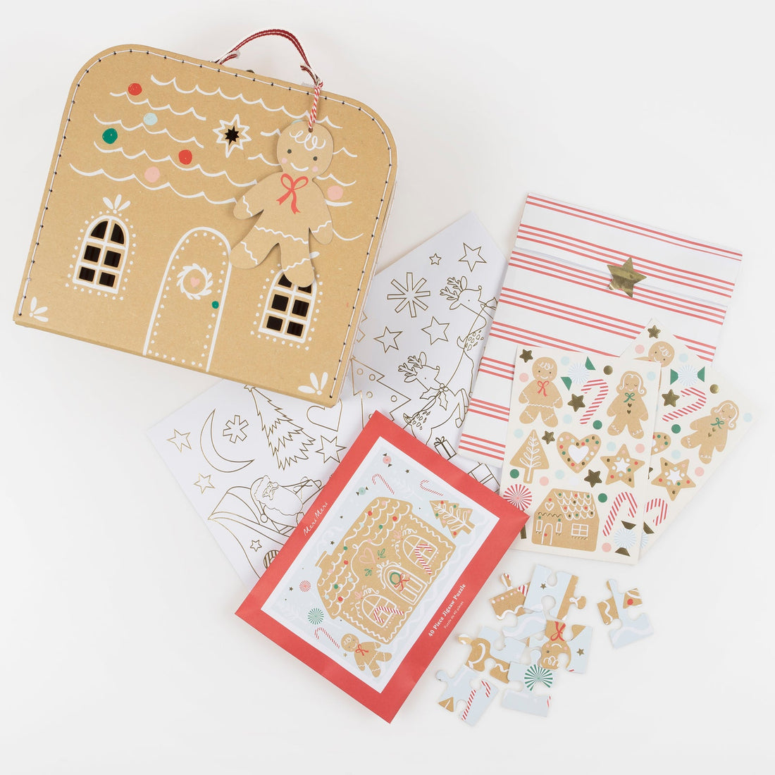 Gingerbread-themed stationery items including a house-shaped pouch, coloring pages, and stickers on a white background.