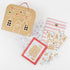 Gingerbread-themed stationery items including a house-shaped pouch, coloring pages, and stickers on a white background.