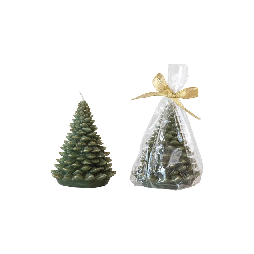 Green Christmas tree-shaped candle next to a clear bag with a gold bow containing more candles on a white background