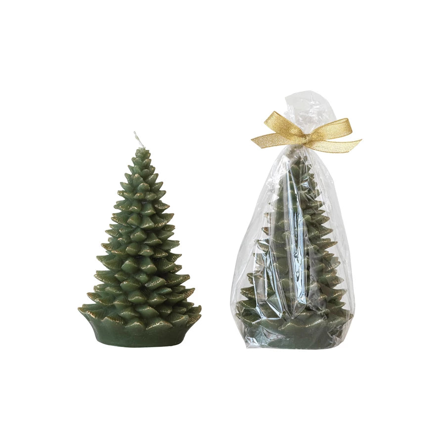 Green Christmas tree-shaped candle next to a wrapped candle in clear plastic with a gold bow on a white background