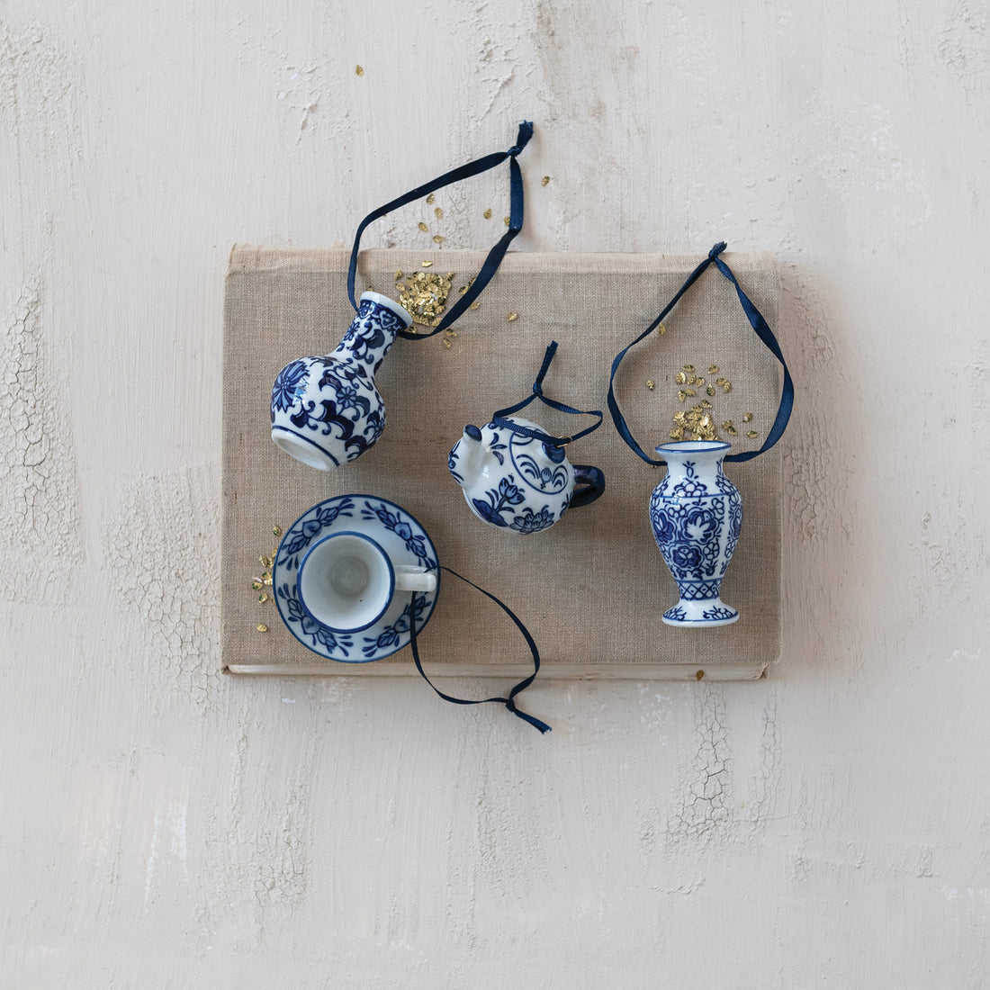 Set of blue and white ceramic pottery ornaments on a textured surface