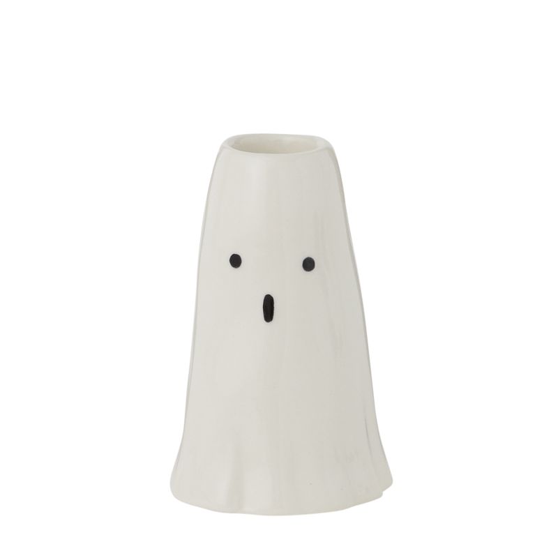 A Phantom Candleholder on a table surrounded by candy corn.