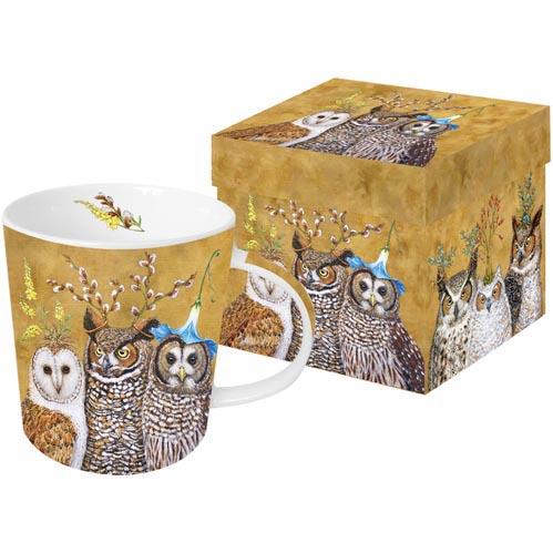 Mug featuring artwork by Vicki Sawyer depicting a group of 3 owls with various flowers and greenery on their heads. 