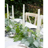 Dinner table set with green pressed glass taper candle holders on it. 