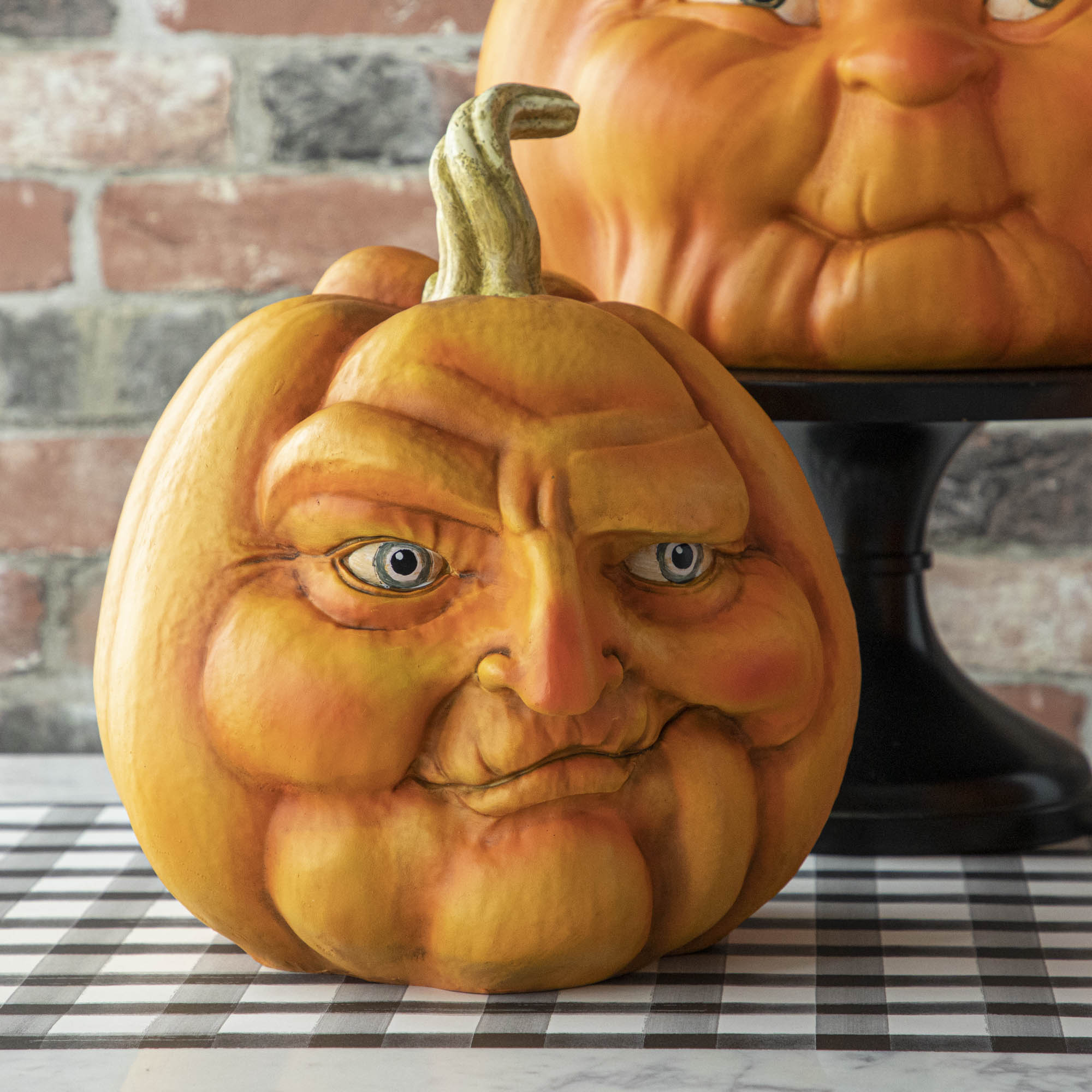 A resin pumpkin with a smirking face.
