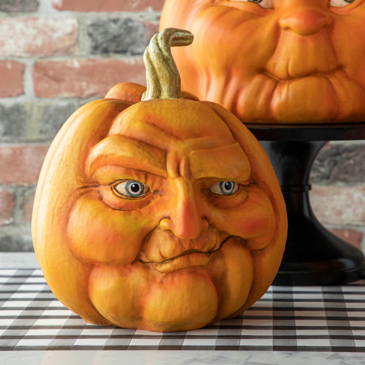 A resin pumpkin with a smirking face. 