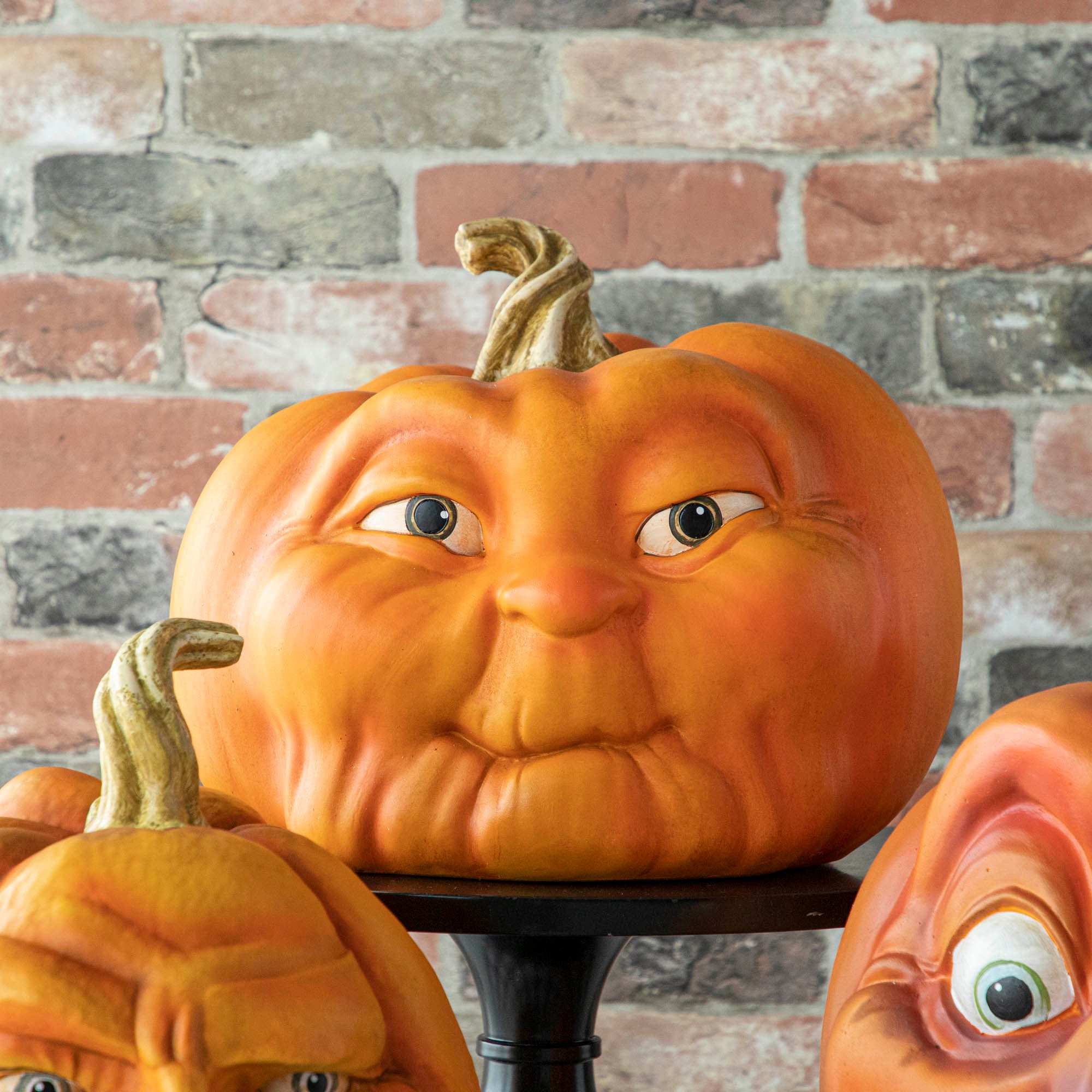 A resin pumpkin with a face on it.