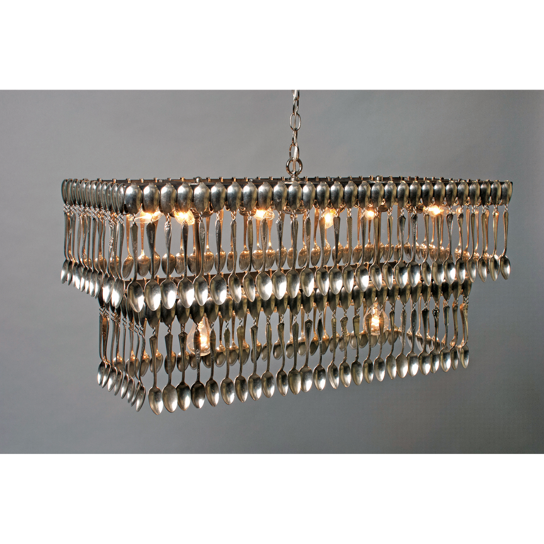 Double Tier Rectangular Spoondelier with multiple reflective pendants against a gray background by Hester & Cook.